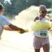 A runner is sprayed with yellow powder in the Ypsilanti Color Run 5K on Sunday morning. Melanie Maxwell I AnnArbor.com